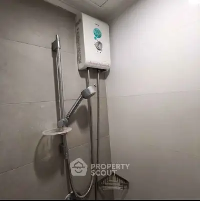 Modern bathroom with sleek shower and water heater in a minimalist design.