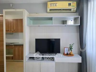 Modern living room with TV, air conditioner, and stylish decor