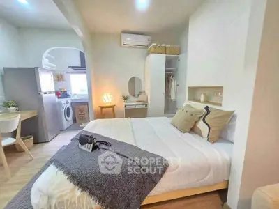 Cozy studio apartment with modern kitchen and stylish decor, perfect for urban living.