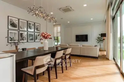 Spacious modern living room with elegant dining area and large windows for natural light.