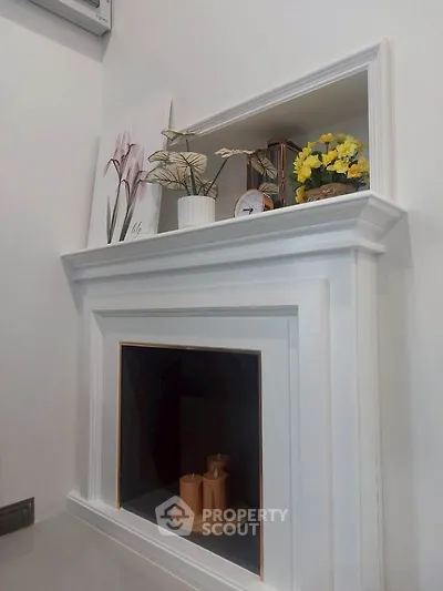 Charming interior with elegant white fireplace and decorative accents.