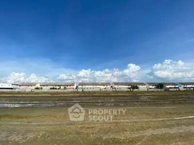 Expansive view of residential buildings under a clear blue sky, perfect for development opportunities.