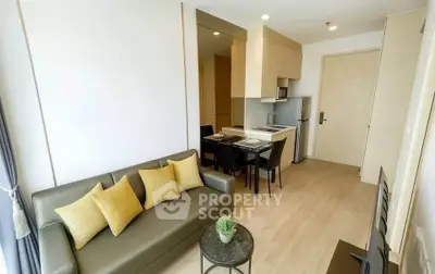 Modern living room with stylish furniture and open kitchen layout in a cozy apartment.