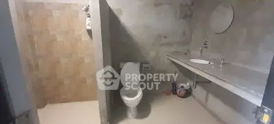 Spacious bathroom with modern fixtures and walk-in shower.