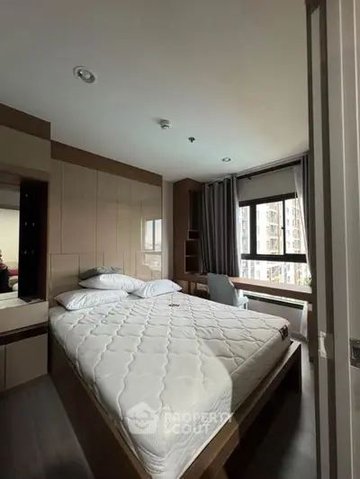 Modern bedroom with large window and stylish decor in urban apartment