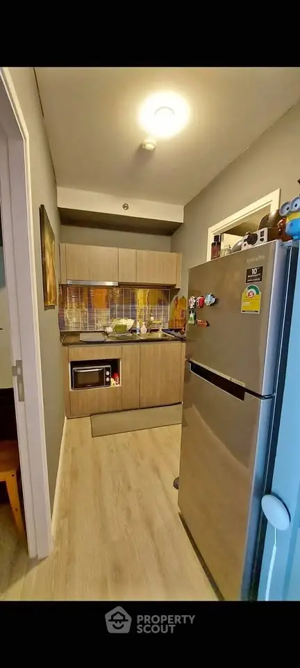 Modern kitchen with sleek appliances and stylish cabinetry, perfect for urban living.