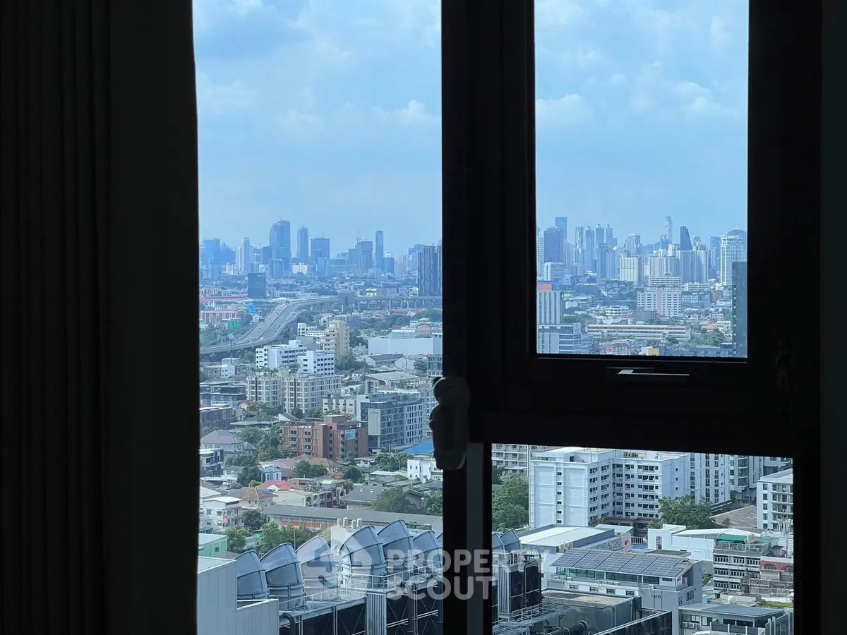 Stunning cityscape view from high-rise window showcasing urban skyline and vibrant city life.