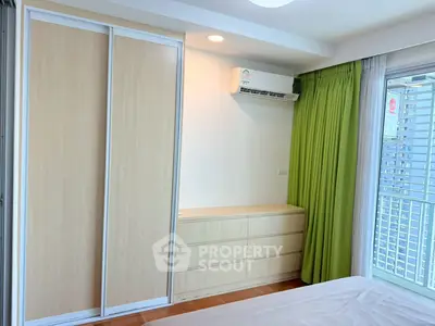 Modern bedroom with built-in wardrobe and air conditioning