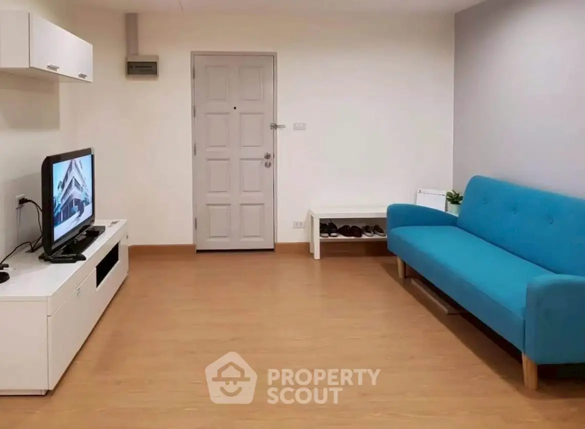 Modern living room with blue sofa and TV, minimalist design