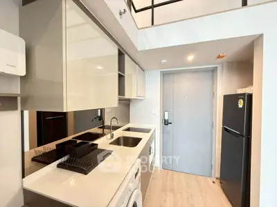 Modern kitchen with sleek cabinetry and appliances in a stylish apartment