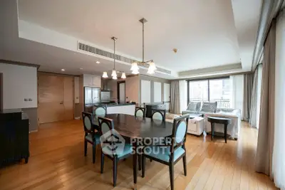 Spacious open-plan living and dining area with elegant furnishings and natural light.
