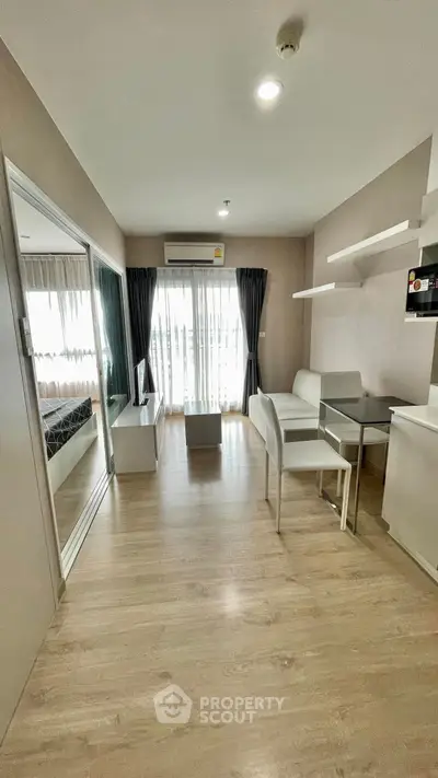 Modern living room with sleek furniture and large windows in a stylish apartment.