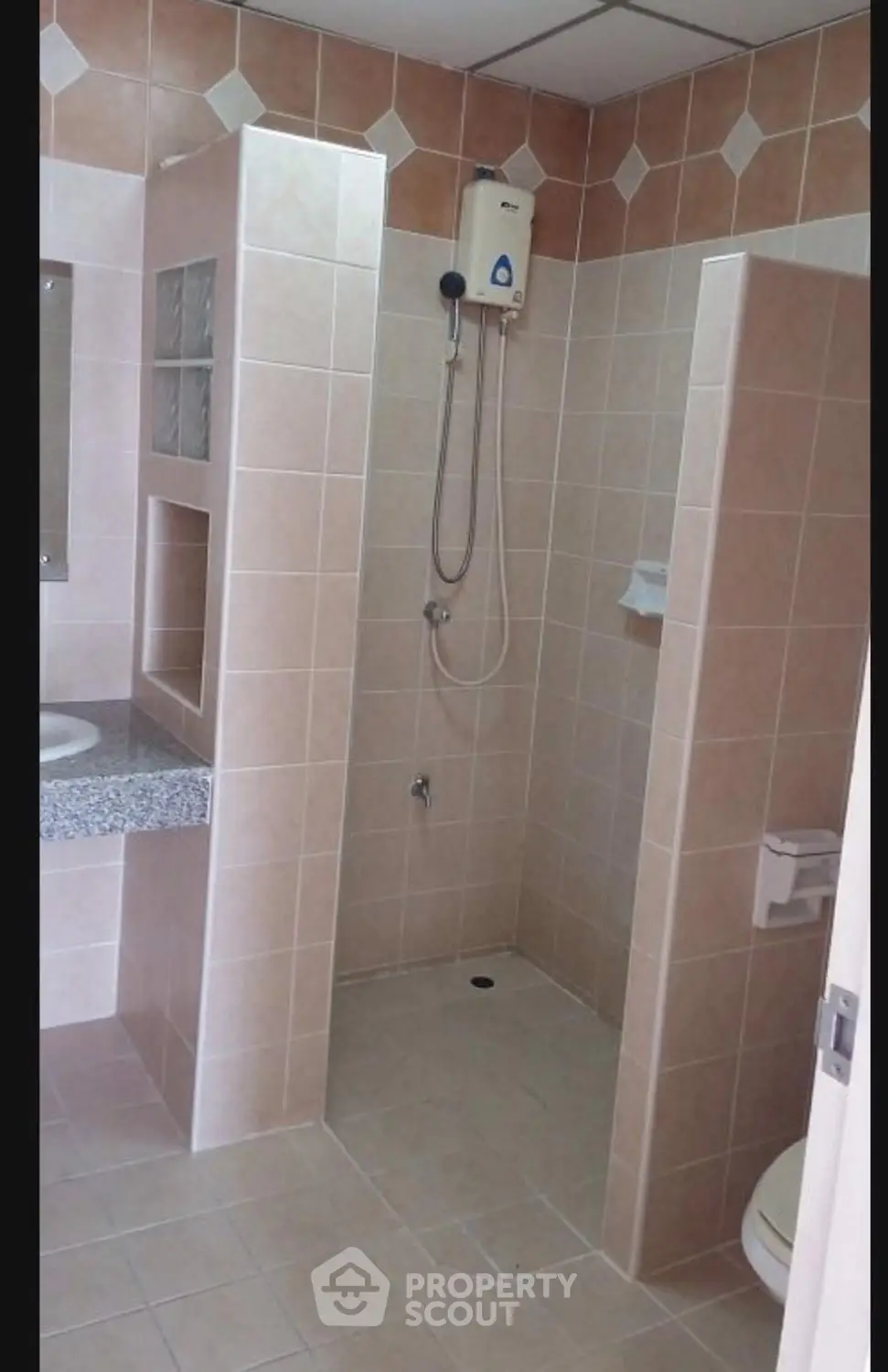 Spacious bathroom with modern shower and tiled walls