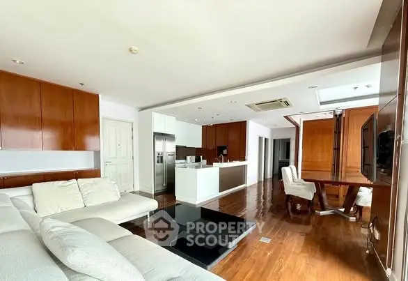 Spacious modern living room with open kitchen and elegant wooden flooring