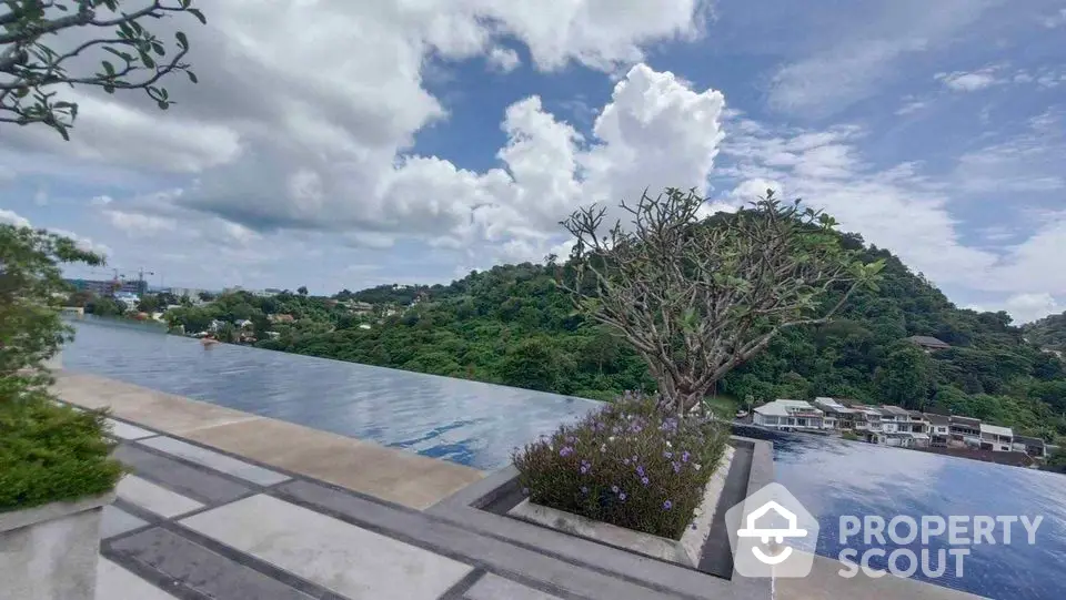 Stunning infinity pool with panoramic mountain views and lush greenery