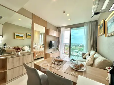 Modern open-plan living room with dining area and balcony view