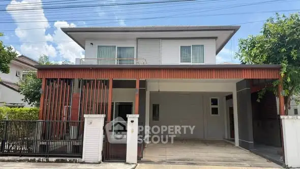 Modern two-story house with spacious carport and contemporary design in a serene neighborhood.