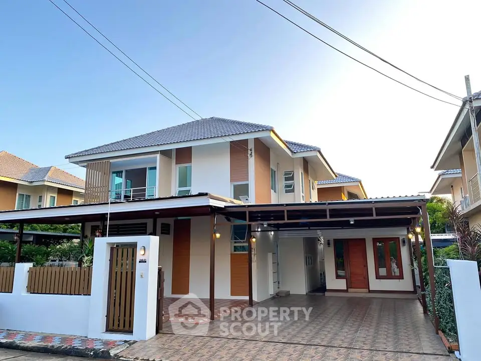 Stunning modern two-story house with spacious driveway and elegant design.