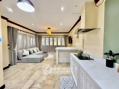 Spacious open-plan living room with modern kitchen and cozy seating area