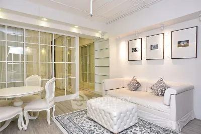 Elegant living room with stylish decor and cozy seating area in modern apartment.