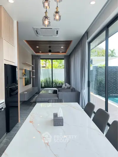 Luxurious modern living room with pool view and elegant marble dining table.