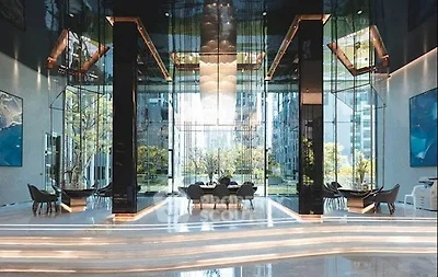 Luxurious modern building lobby with elegant design and stunning outdoor view.