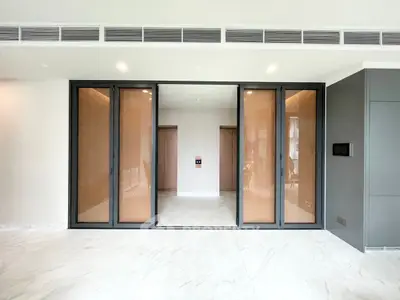 Spacious modern living room with sliding glass doors and marble flooring