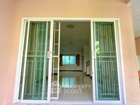 Spacious living room with sliding glass doors and natural light, perfect for modern living.