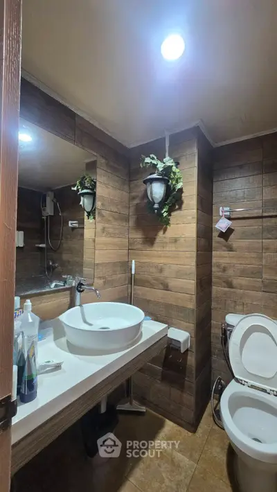 Modern bathroom with wooden paneling and stylish fixtures