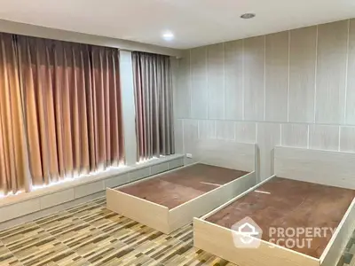 Spacious bedroom with modern wooden flooring and elegant dual-tone curtains, ready for customization and personal touch.