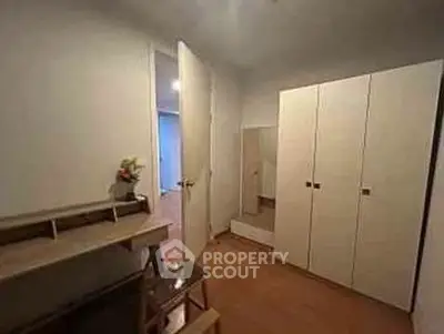 Cozy bedroom with wardrobe and desk, ideal for a comfortable living space.