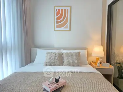 Cozy bedroom with stylish decor and soft lighting, perfect for relaxation and comfort.