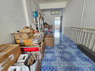 Spacious storage area with blue patterned floor tiles and organized shelving.