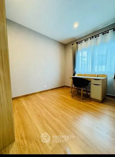 Bright study room with wooden flooring and modern desk setup