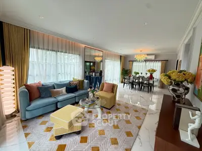 Luxurious living room with elegant decor and spacious dining area, featuring modern furniture and stylish lighting.
