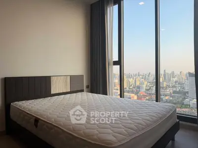 Spacious bedroom with stunning city view from floor-to-ceiling windows, featuring a comfortable bed and modern decor.