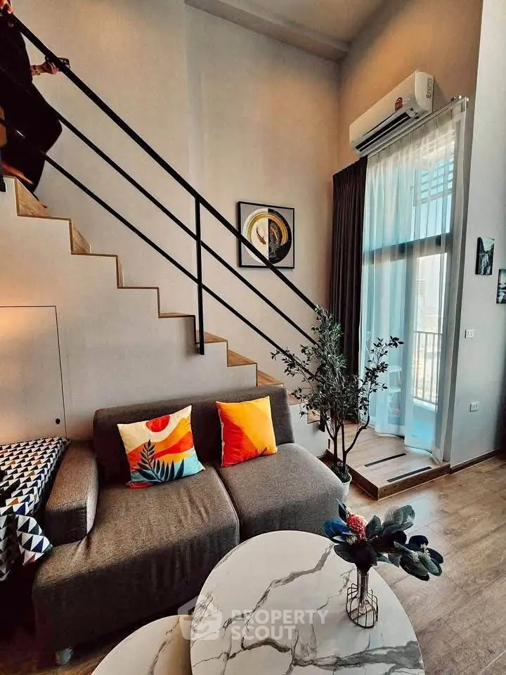 Modern loft-style living room with high ceilings and stylish decor