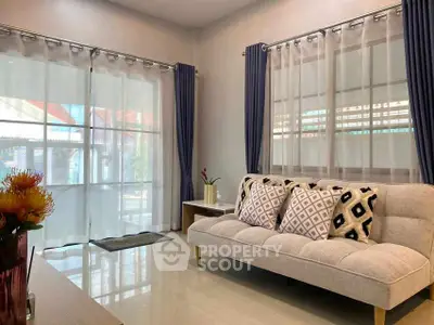 Modern living room with stylish sofa and large windows for natural light.