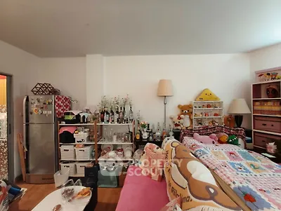 Cozy living room with eclectic decor and ample storage space.
