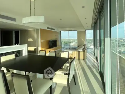 Luxurious modern living room with panoramic city views and elegant dining area.