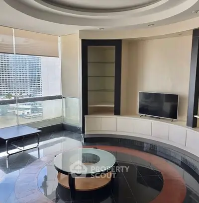 Luxurious living room with modern design and city view, featuring sleek furniture and large windows.