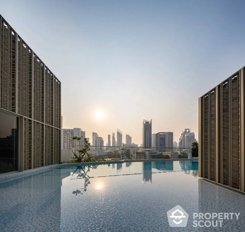 Luxurious rooftop infinity pool with stunning city skyline view at sunset.