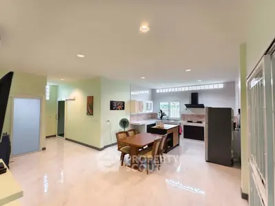 Spacious open-plan kitchen and dining area with modern appliances and ample natural light.