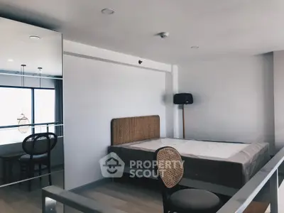 Modern bedroom with minimalist design and large mirror, perfect for urban living.
