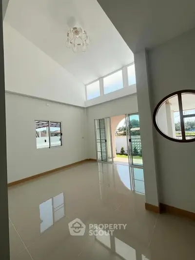 Spacious modern living room with high ceilings and large windows