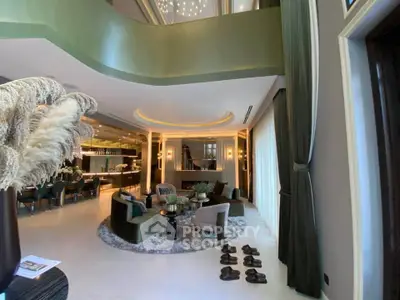 Luxurious open-plan living room with elegant decor and modern lighting in a high-end property.