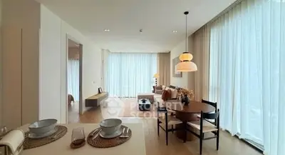 Spacious modern living room with elegant dining area and floor-to-ceiling windows