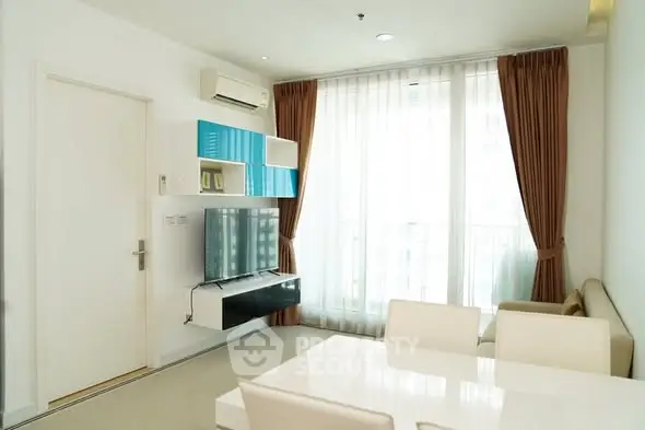 Modern living room with sleek furniture and large window for natural light