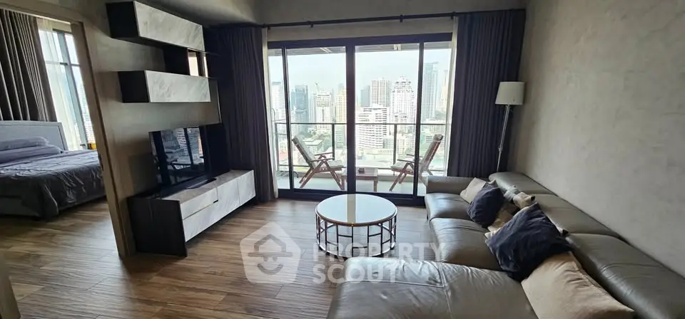 Modern living room with city view, featuring stylish furniture and a cozy balcony.