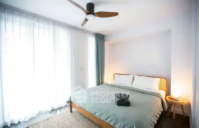 Bright and cozy bedroom with large window and modern decor